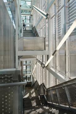 The stair towers’ glass enclosure is covered in perforated stainless steel panels to prevent graffiti. Only the elevator cores were left simply glazed. “Those are all exposed,” Ross Barney explains, “because if people can be seen, then they feel safer.”