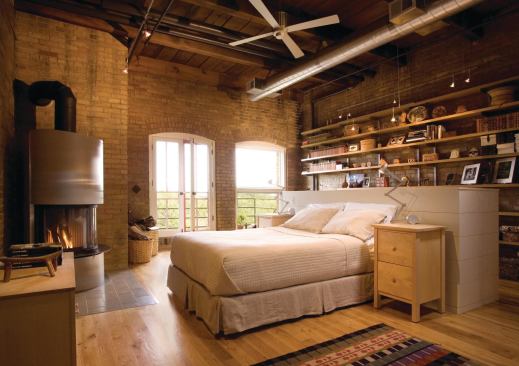 The headboard in the master bedroom conceals a desk. 