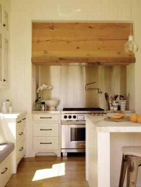 The range hood is faced with the same reclaimed oak as the floor.

