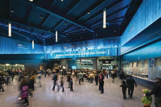  After passing under the 85-foot-deep cantilever and through the main entrance, visitors arrive in the atrium, where they can pick up tickets and get their first glimpse into the arena proper.