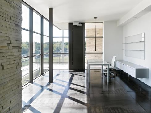 The lobby overlooks the facility’s wind turbine and sports a series of monitors that display the building’s energy consumption in real time.