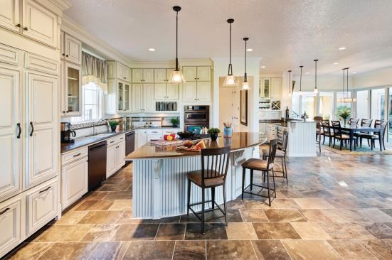 Let’s Get Cooking The open-plan kitchen flows into both indoor and outdoor living and dining spaces—ideal for entertaining. The flared work island has a powerful gas cooktop, ample workspace for diehard cooks, and enough seating room for lounging onlookers. In this open and casual living space, no one misses out on the conversation or the action.