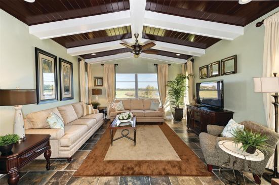 A living room that’s just off the kitchen provides a seating area that’s open to the rest of this open plan living area.
