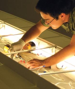 A student installs some of the interior wiring.