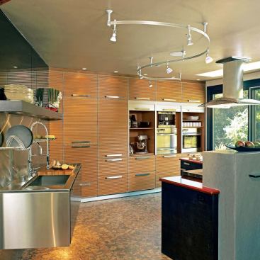What you donÕt see in this cosmopolitan kitchen are details ranging from the conscientious to the sublime: a built-in composter beneath the custom cutting board (above) neatly eliminates waste and a mirror above the cantilevered sink (right) becomes a giant TV screen with the flick of a switch.