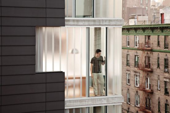 The building's skin is peeled back and channel glass brings in light but permits privacy