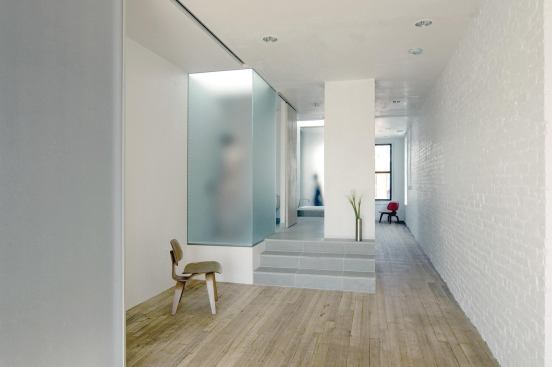 Translucent, acid-etched glass surrounds the loft's bathtub and showers, allowing these spaces to serve as light sources within the loft.