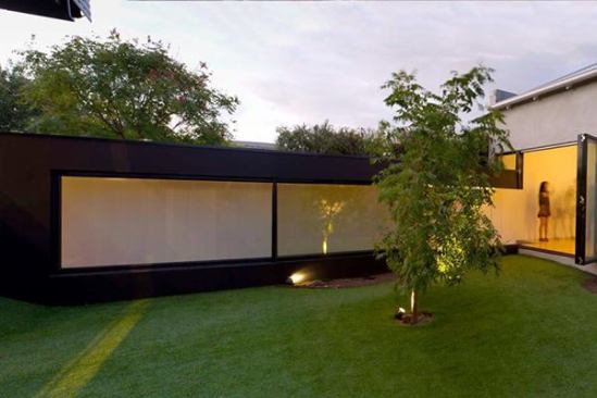 A deep wall links the existing house to the new spaces, provides privacy from nearby neighbors, and opens up as a really long window seat running the length of the courtyard.