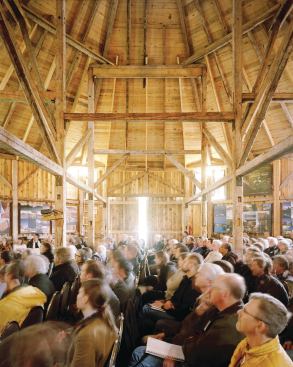 Attendees listen to presentations made in the hexagonal barn on Shobac Farm.