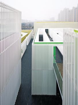  Much of the circulation around the Youth Center complex is outdoors, in gray-paved alleys and over bridges that run like streets through the site.