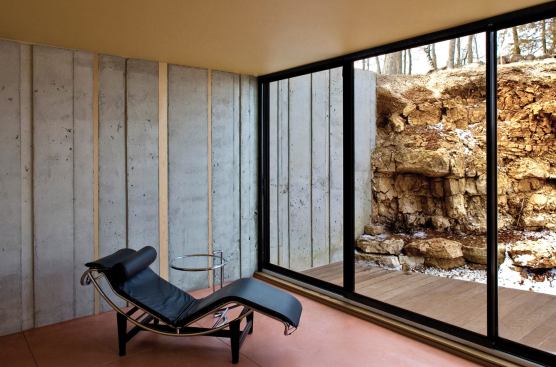 2007 RADA project of the year  camouflage house, green lake, wis.  principals in charge / project architects / landscape designers / interior designers: Brian Johnsen, AIA, and Sebastian Schmaling, AIA, Johnsen Schmaling Architects; general contractor: Jesse Burg, Gale Burg Construction, Malone, Wis.   Concrete retaining walls rise out of existing rock outcroppings, strengthening the building’s connection to the site.