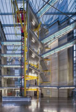 The lighting follows the architecture's economy, using T5 fluorescents to delineate the undersides of the bridges and lightpipe to highlight the verticality of the stair core (bottom).