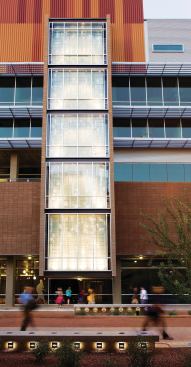 A strip of vertical glazing on the south façade--fitted with an installation of floating aluminum shards by artist and lighting designer Paul Deeb--is made of double-skinned frosted glass. The tower reveals the main public stair and creates a cooling vent with the movement of air through its double skin. SOLAR CHIMNEY - Vox Manufacturing - Custom solar chimney and illuminated art wall - voxarts.com - MASONRY - Western Block - Exterior masonry system - westernblock.com