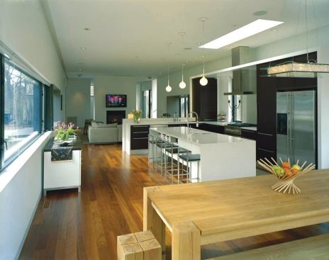 The kitchen, which features wenge cabinets and quartz counters, opens into the dining area and the living room.