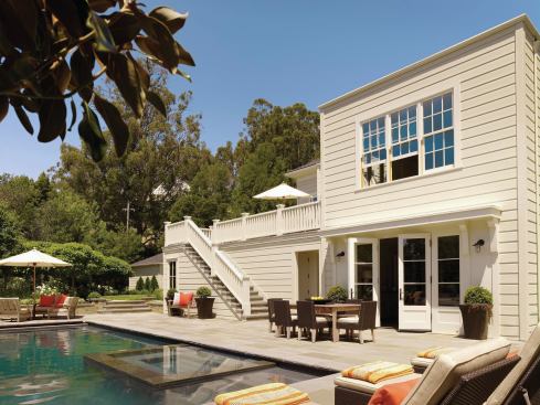 Relocating the lower-level garage to its own separate building freed space for a family room that opens onto the backyard pool deck.

