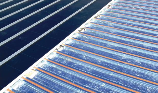 The Solar Sandwich roofing system contains a solar thermal system in an otherwise ordinary-looking roofing system.