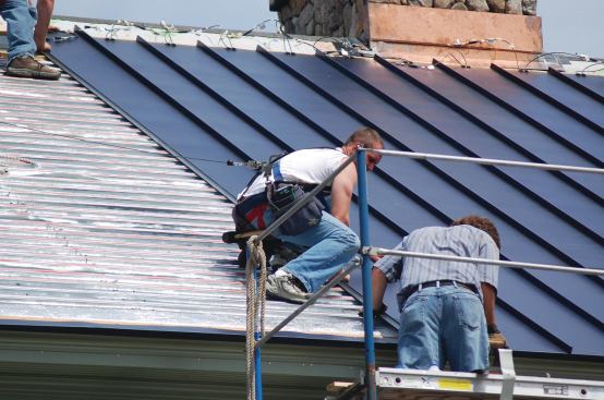 The installed photovoltaic roofing panels conceal the glycol heat exchanging system underneath.