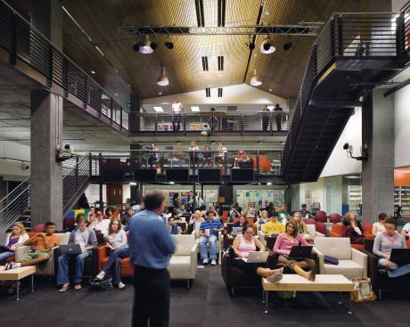 A central triple-height space is used for lectures and presentations and can accommodate different numbers with movable furniture. The space engages students and faculty on three different levels, with additional seating on a landing on the internal stairway. LOUNGE SEATING - Carolina Business Furniture - Retrospect seating - carolinabusinessfurniture.com - CEILING - 9wood - Linear wood ceiling - 9wood.com - PENDANT LIGHTING FIXTURES - Beta Calco - Belaro reflector fixtures - betacalco.com