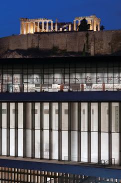 The New Acropolis Museum sits in the shadow of the Parthenon, its uppermost gallery set parallel to the ancient temple.