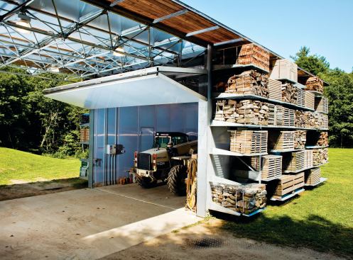 The building was designed around the proportions of the 4-foot-wide pallets and around the turning radius and width of the loader used to move them. A bi-fold door can close to keep the loader secure and out of the elements.