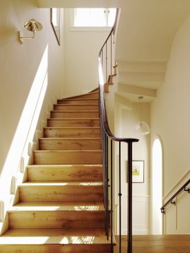 A light-filled new stairway connects the first-floor living space with bedrooms at the second and lower levels.

