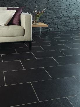 Ceramic Coal, the latest addition to 
Amitco’s Spacia line of resilient flooring, uses charcoal tones and gray mottling to mimic the visual depth and dimension of stone. With a ceramic finish, urethane coating, and beveled edges, it can be used in residential and commercial applications alongside the company’s line of wood, stone, and abstract flooring options. The designs come in 12-inch-by-12-inch, 12-inch-by-18-inch, and 18-inch-by-18-inch sizes, and are 2.5 millimeters thick. Amitco International. 800.268.4260. 
www.amitco.com.