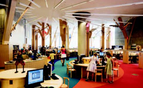 Surface-mounted T5s in playful radial patterns on the ceilings of the children's section of the library, add interest and ambient illumination.