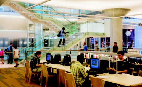 Rectangular indirect linear pendants containing T5 fluorescents and fitted with asymmetric reflectors and frosted lenses illuminate the ceilings of each floor. Linear fluorescents hidden along the front edge of low stacks wash the books with a minimum of 20 footcandles of light. Small LED strips highlight the edges of the wood frame of the staircase.
