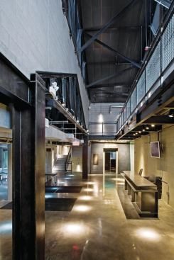 The first room visitors enter is the Prologue, a dark space with no access to natural light and with a raw materiality expressed in concrete floors, CMU walls, and a heavy steel reception desk.