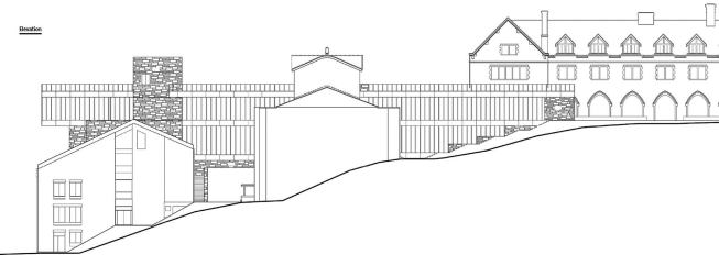 The hillside site resulted in a four-floor building that is hidden from view at the main entrance, a single-story volume on the northwest end. The two uppermost floors contain classrooms and offices, and they bridge a pathway before joining the two lower levels at the base of the hill.