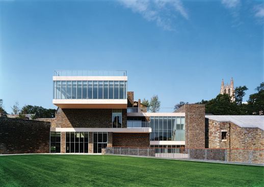 The project includes several green roof strategies. By applying field turf to the roof of an existing pool building (foreground), the architects created an outdoor recreation area directly off the student center. The glass guard rail on top of the cantilevered top story protects another planted green roof, this one with sedum and pavers. The next phase of the project will add a pavilion-like, glass-enclosed conference room to that top-most green roof, for use by faculty or for special events.