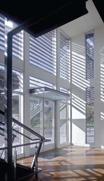 A two-story lobby in the center of the building provides a view corridor from land to sea and allows maximum light into upstairs office spaces.