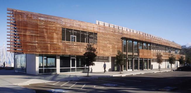 The new Harbormaster's Building is a long, thin structure, located on a series of public docks. An ipe screen clads the landside face of the building.