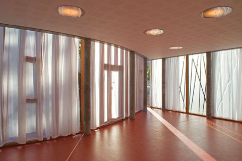 Natural light grazes the floor in the nursery. Custom-designed ceiling fixtures provide a balance of electric light.