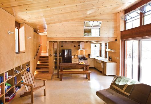 Interior materials include a variety of salvaged woods and sprayed earth plaster. 