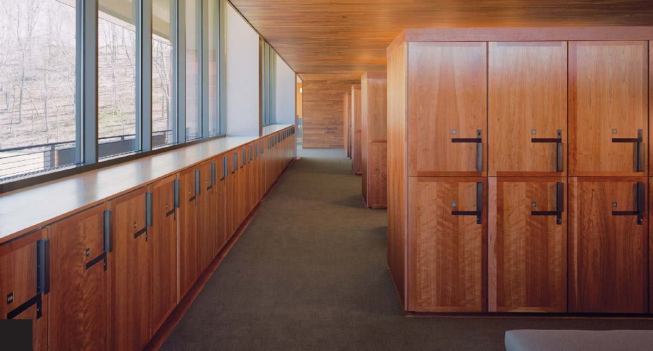 The cherry wood continues into the private realm of the men's changing room on the second floor, which features custom lockers.