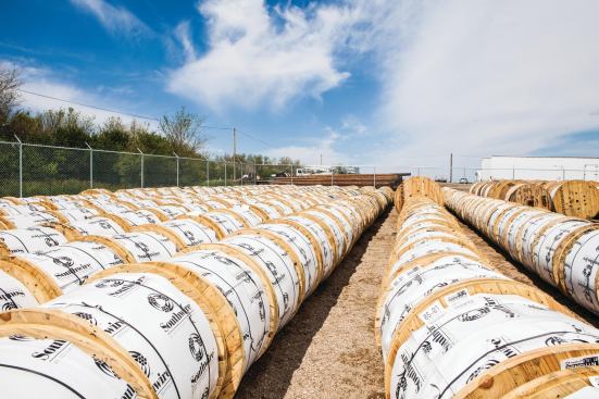 Spools of electric cable in storage.