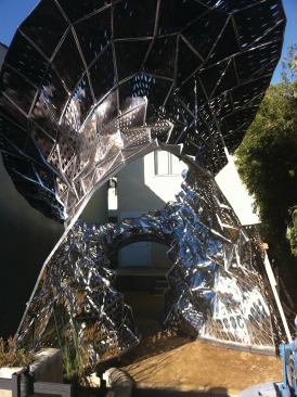 Final monocoque form of a self-supporting, hyperbolic paraboloid structure comprising Bloom panels.