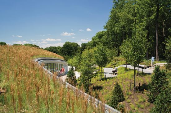 The northern edge of the visitor center is embedded into a berm. Visiors can access this higher ground, with its terraced seating and access points to the surrounding garden environments, via the exterior staircase on the other side fo the building.