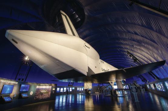 Cantilevering 29 feet above the exhibit floor and outfitted with multiple 70W PAR30 metal halide accent lights fitted with 30-degree snoots, the light is thrown 20 feet to dramatic effect bringing the shuttle to life.