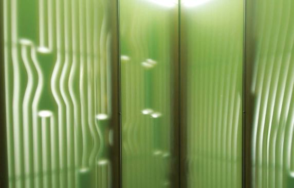 Light from the surrounding hallways flows through the incised tooling paths on the north, south, and west walls, creating a luminescent quality when diffused by the linoleum surface laminated onto the MDF sheets.