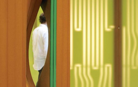 The east wall's undulated form creates small openings where it is possible to look between the slide library and hallway.