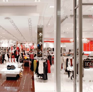 Despite the intensity of the lighting scheme, the effect is one of highlighting the actual clothing and accessory products in the store.