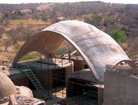 The Mapungubwe National Park Interpretive Centre is sustainable in many ways. Among them: (1) The vaults are composed of locally made stabilized earth tiles and designed to be structurally sound with a minimum use of material and at the lowest cost possible; (2) the tiles' high thermal mass passively cools spaces and radiates heat at night; (3) as part of the project's Poverty Relief Program, the structures are being built by locals trained in a masonry technique that is quickly and easily learned.