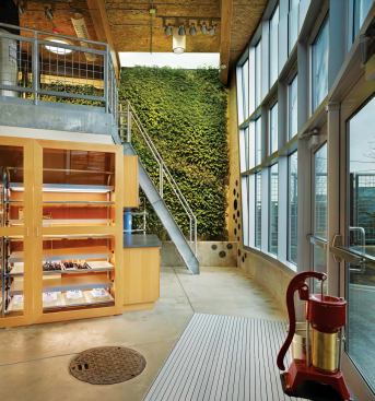 Designed by KMD Architects, the 1,425-square-foot Bertschi School Living Science Building in Seattle features a wastewater-treatment system that reclaims graywater from classroom sinks to irrigate an indoor living wall of tropical plants.