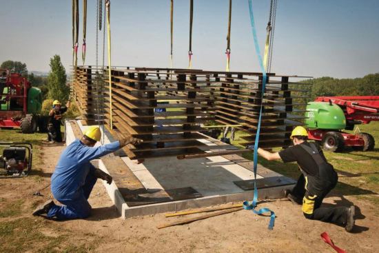 Workers bolted the base layer of metal to the installation's concrete foundation.
