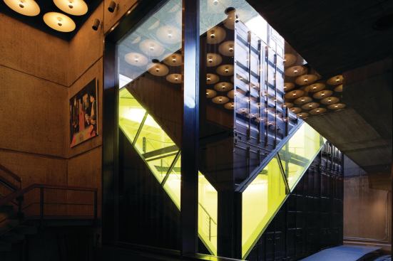 Visitors access the studio by exiting into the courtyard from the museum’s lower level, and enter the studio through a sliding door on its northern face. From inside the Breuer building, there is a clear view to the studio’s vivid yellow glazing—a custom job (with a vinyl film) by Chris Otterbine from the Orchard Group. 