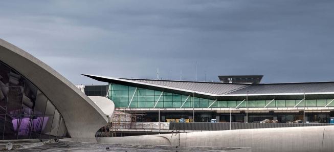 Gensler’s new JetBlue Terminal 5 at JFK airport sits respectfully behind Eero Saarinen’s 1962 TWA terminal (at left), which was placed on the National Register of Historic Places in 2005.