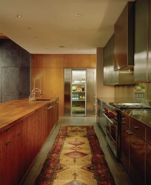 The work island is English brown oak that's oiled, not polyurethaned, with an undermounted sink. Architect Tom Shafer says the oiled wood is "a great product for use around water or food." The island, which serves as both kitchen work island and living room sidebard, has become the "epicenter of the room," he adds. "We wanted it to be a magnet." 


Fifties Love Affair, Winnetka, Ill.: Architect: Grunsfeld Shafer Architects, Evanston, Ill.; General contractor: Rizzolo Brothers Company, Libertyville, Ill.; Interior designer: Insight, Highland Park, Ill.