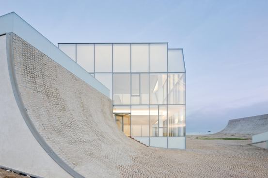 Sloping roof plaza wall with restaurant beyond